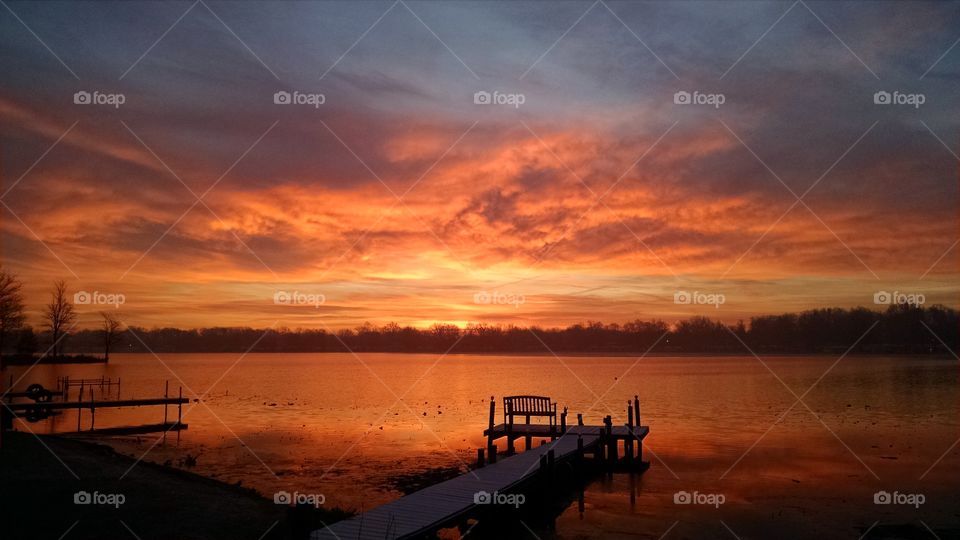 Beautiful Fall Sunrise over a Northern Indiana Lake, Vacant Pier in foreground.