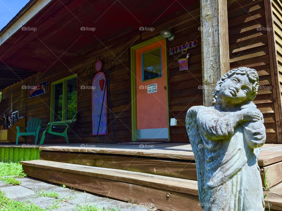 Angel in front of hippy cabin