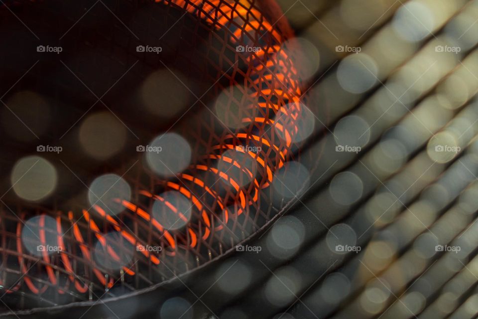 hot red coil and bokeh lights in foreground
