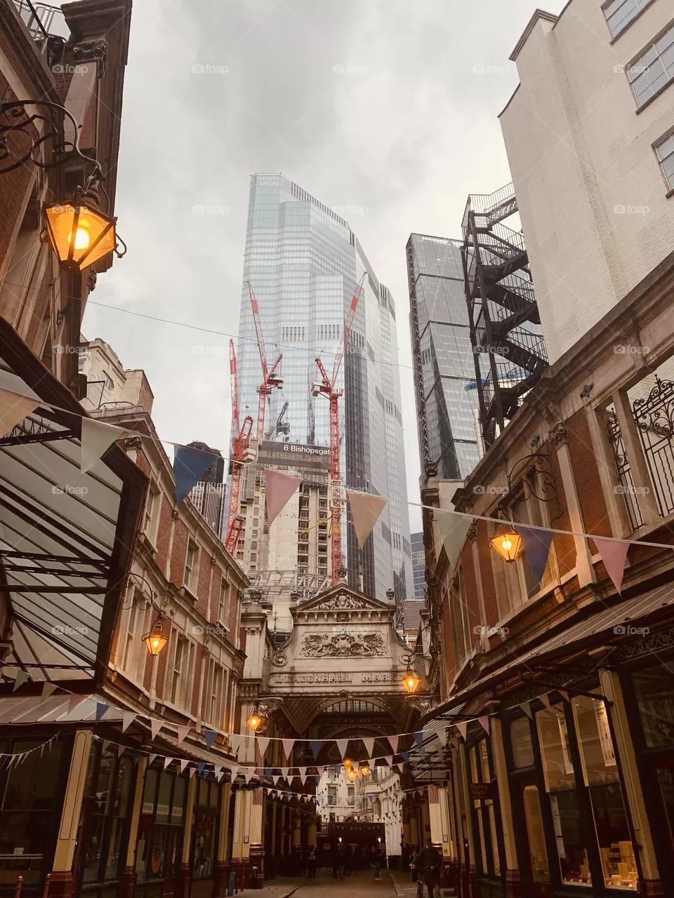 London Leadenhall market with skyscrapers construction site in the background on foggy day 