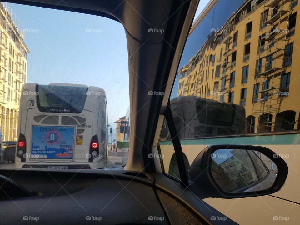 City bus (line 4) and windows of bus line 1 at the right