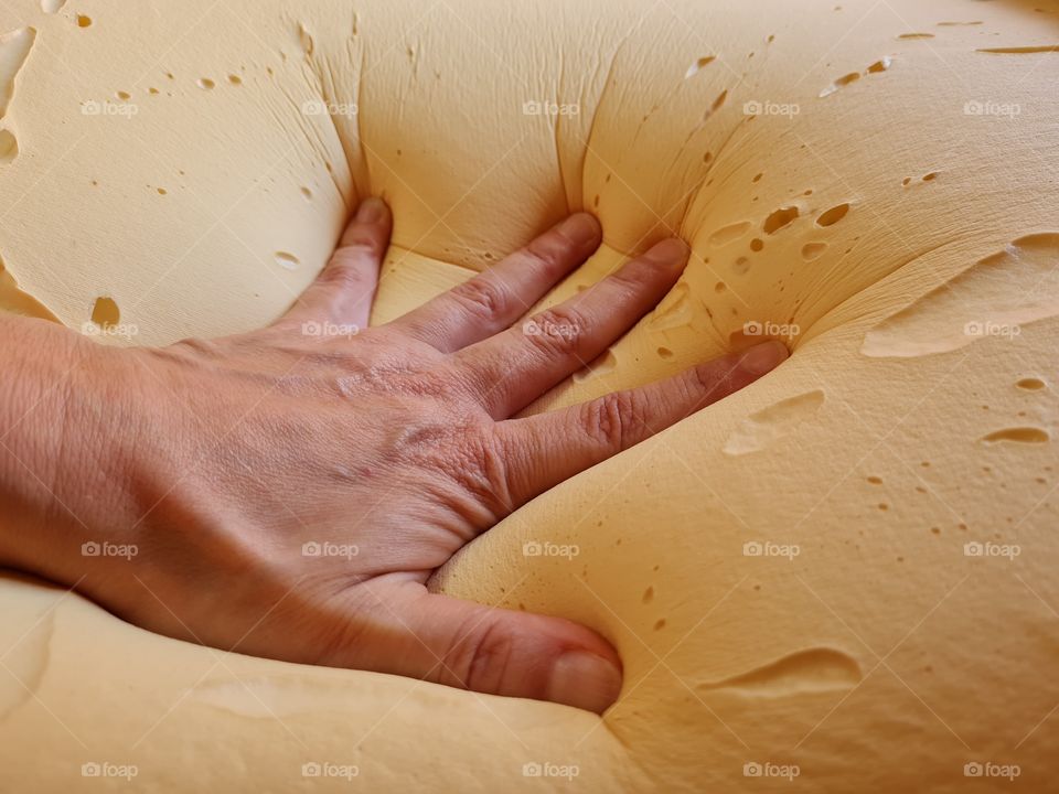 hand sinks onto memory foam pillow