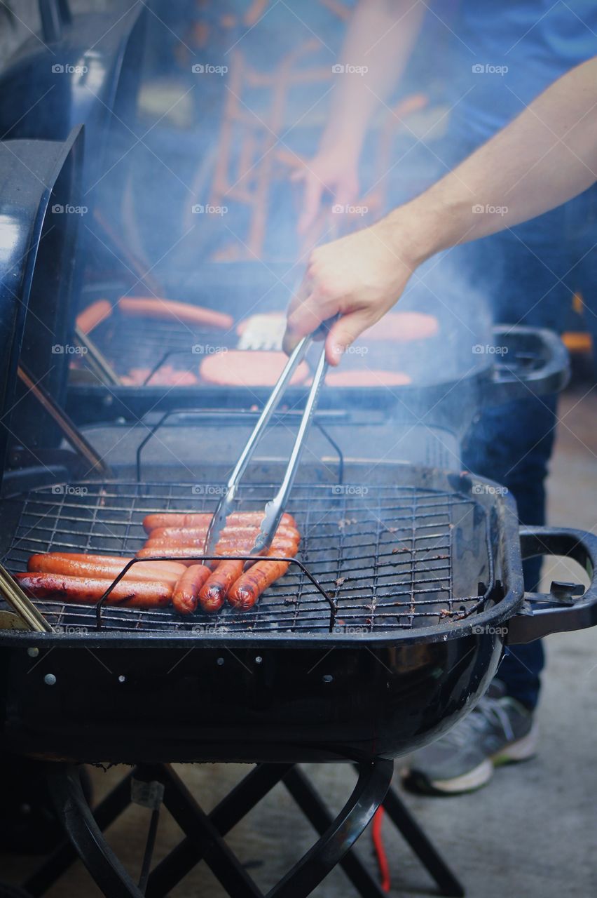 Hot dog grill making food at home backyard 