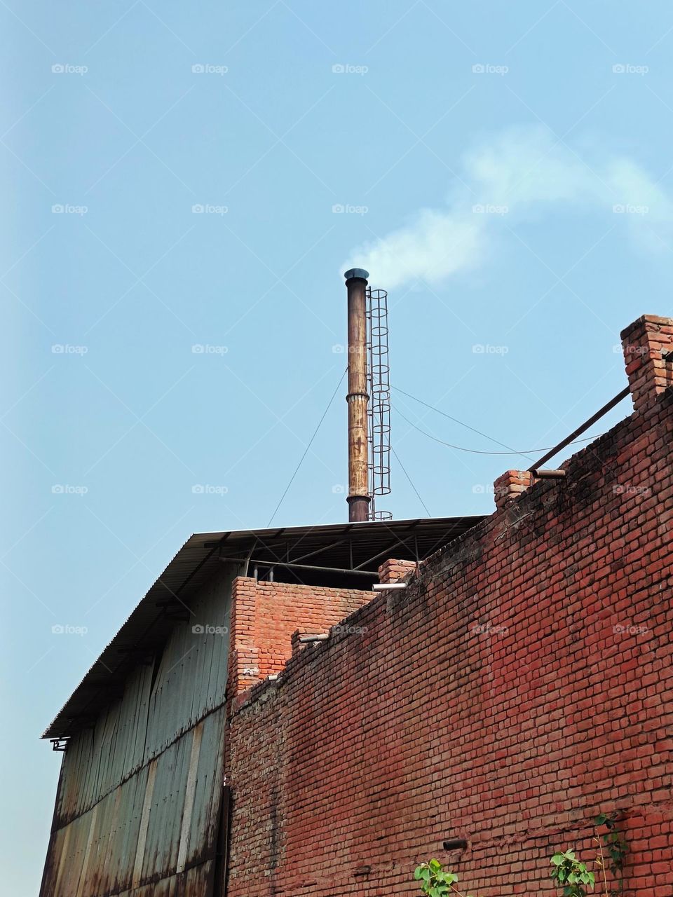 chimney of a factory in industrial area.