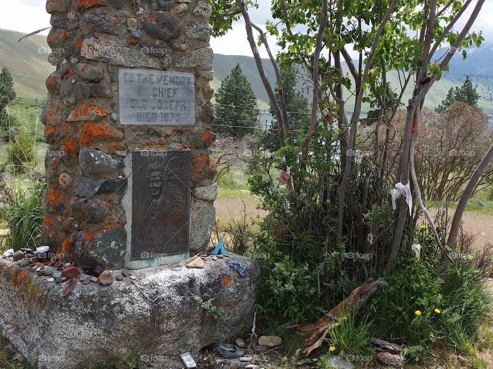 The stone memorial marks the burial site of Chief Joseph in Northeastern Oregon on a spring day. 