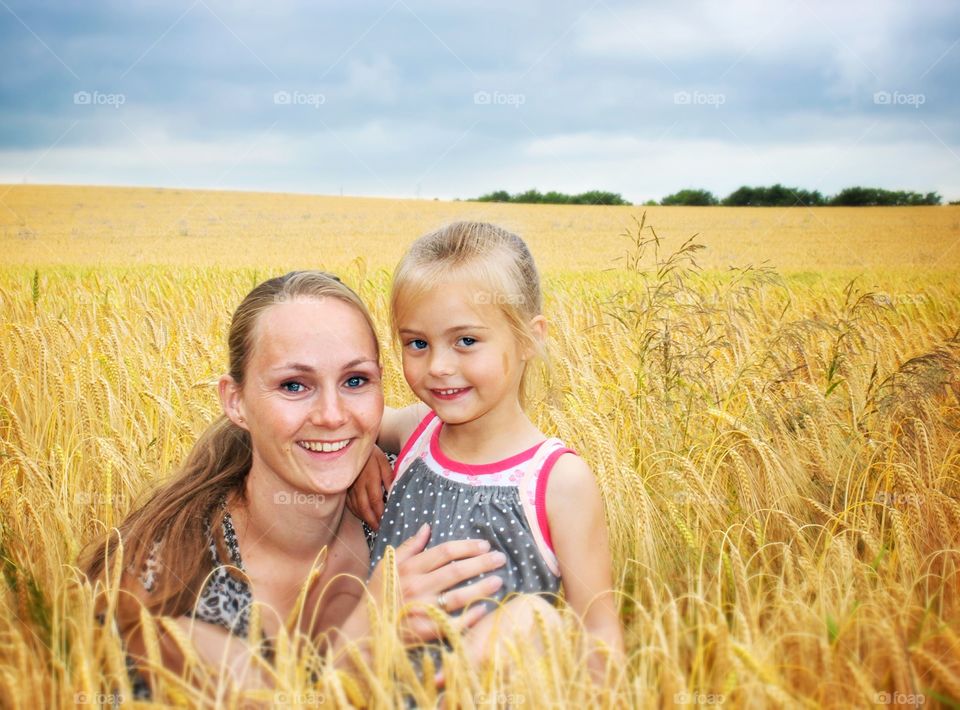 Mother with her child in wheat field