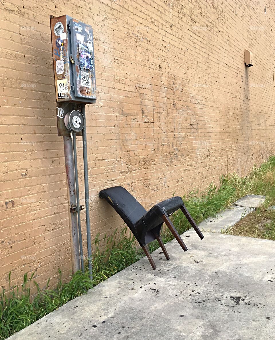 Random chair hanging out in an empty lot.  Ogden, Utah, this is a small historic city in this western state. 