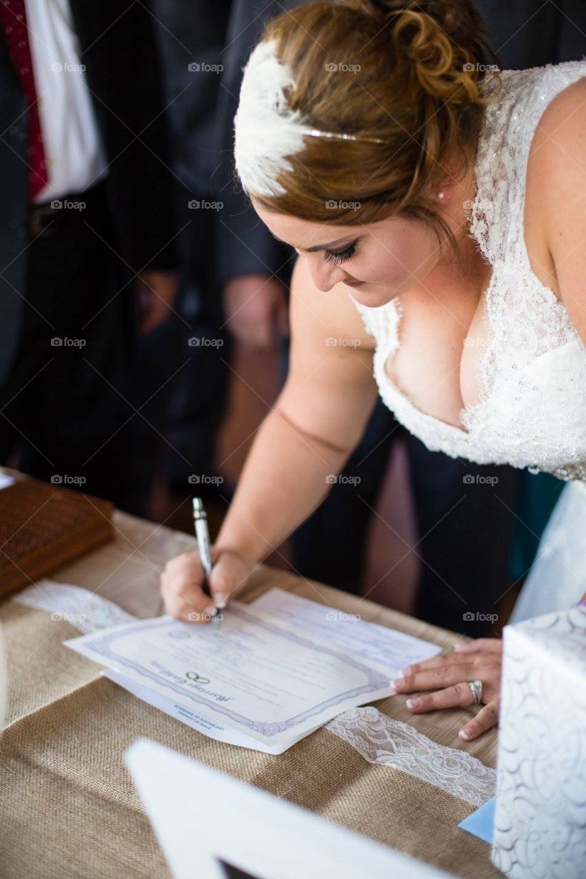 Bride signing marriage license 