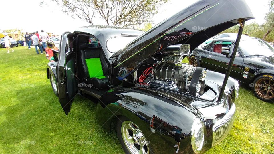 Classic black Roadster with custom lime green interior shines at a Arizona auto show.