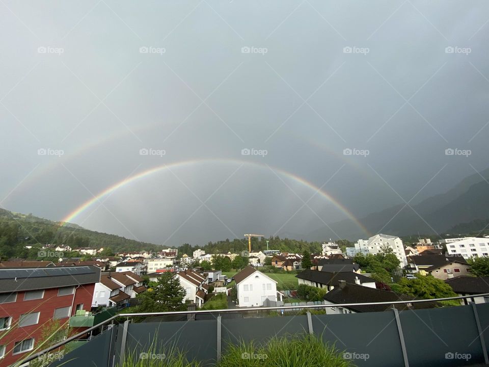 double beautiful rainbow after rain over the city in switzerland