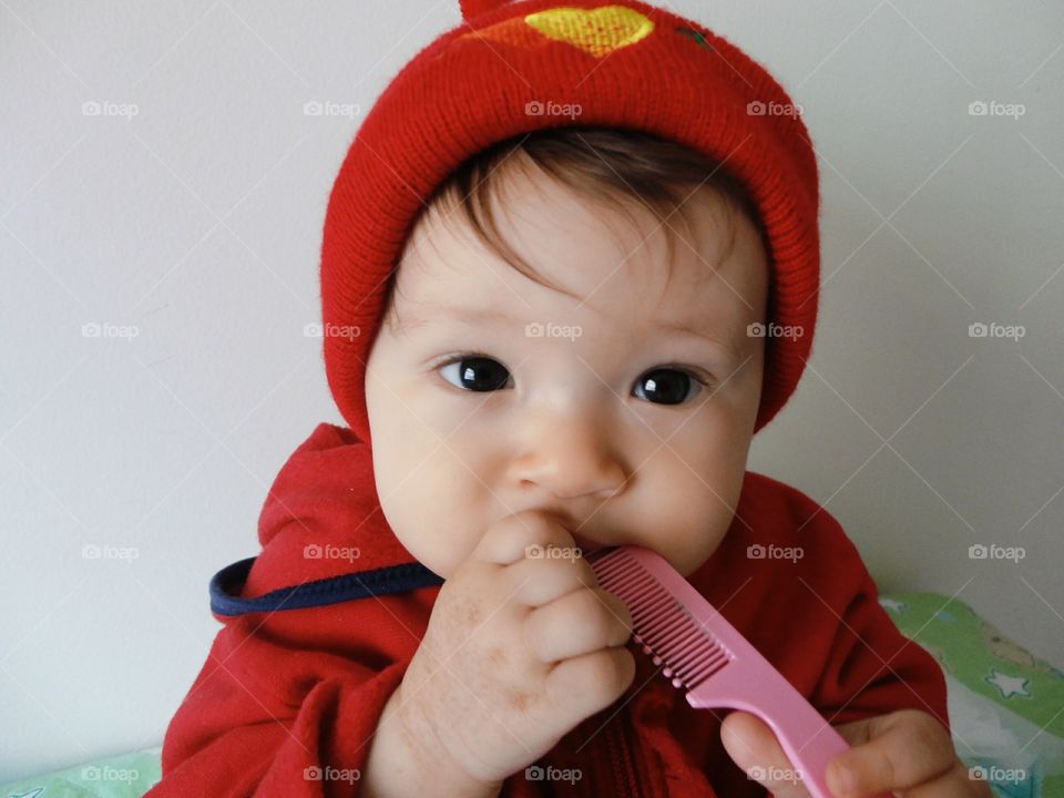 Cute baby holding small comb