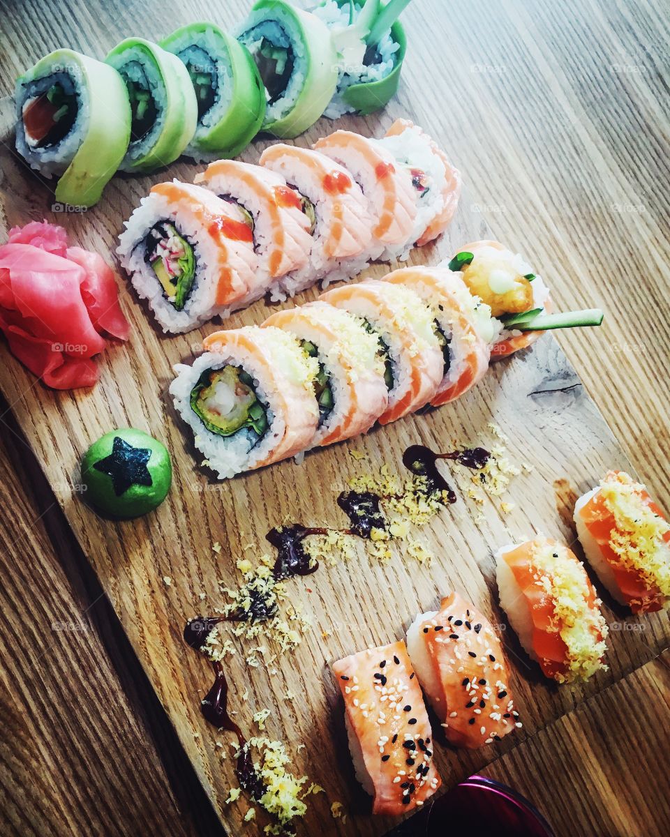 Sushi rolls on wooden table