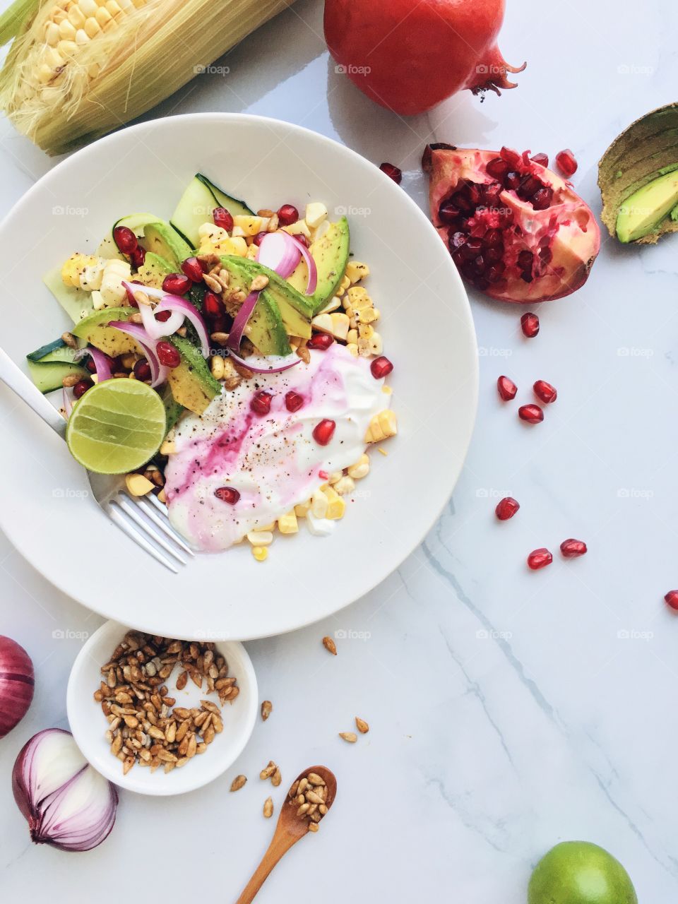 Salad with corn yogurt and pomegranate