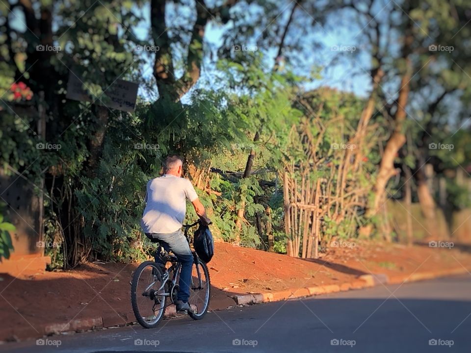 Man returning home after a day’s work, in his bike. Trying to stay fit in a city’ stressful routine.