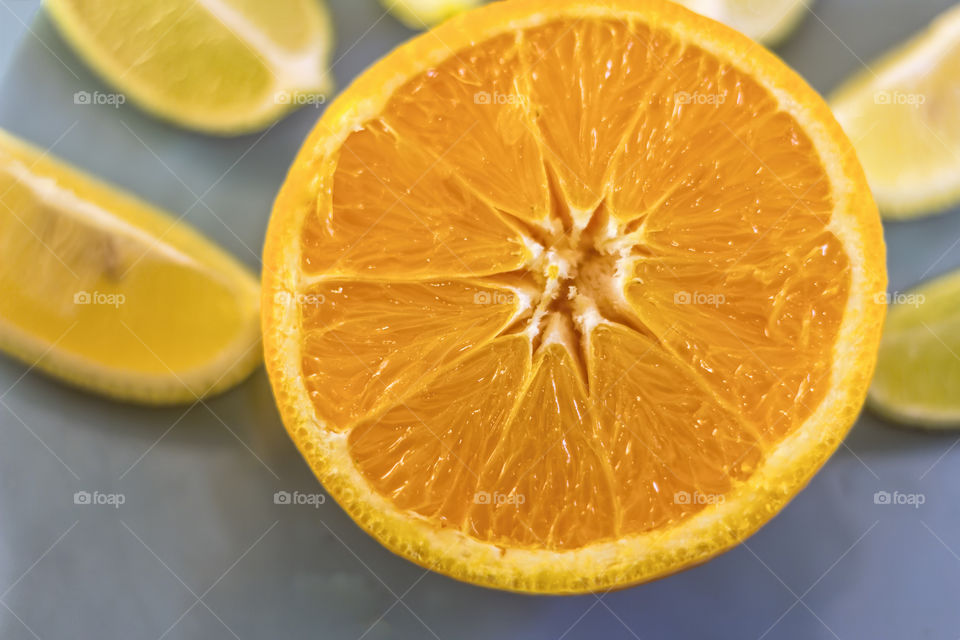 Half orange with lemons and limes