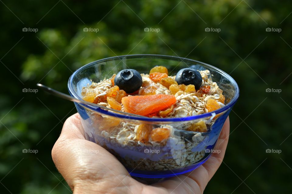 tasty healthy food in the hand green summer background