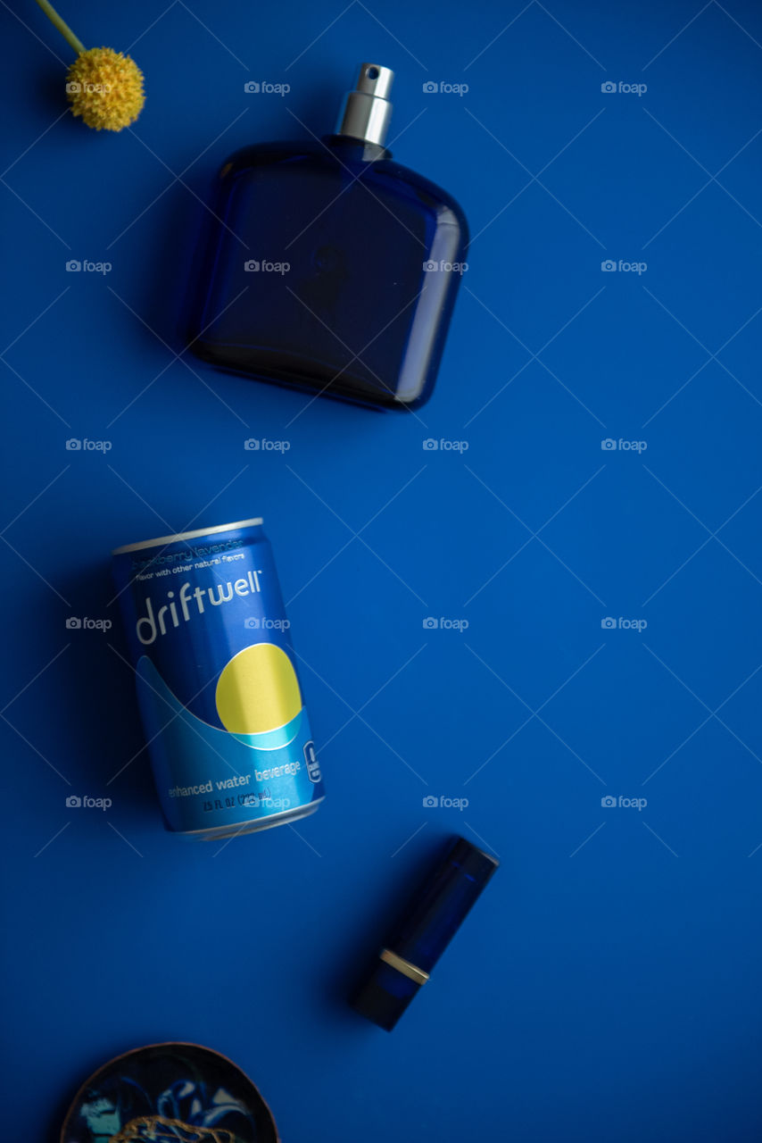 Monochromatic flat lay of a can of Driftwell on a blue background