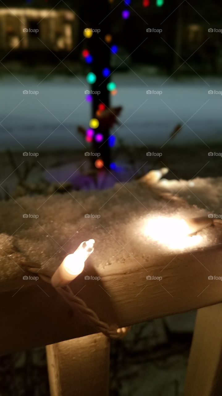 Christmas lights in snow and frost