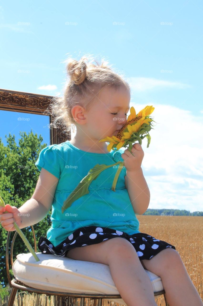 Cute girl with sunflower