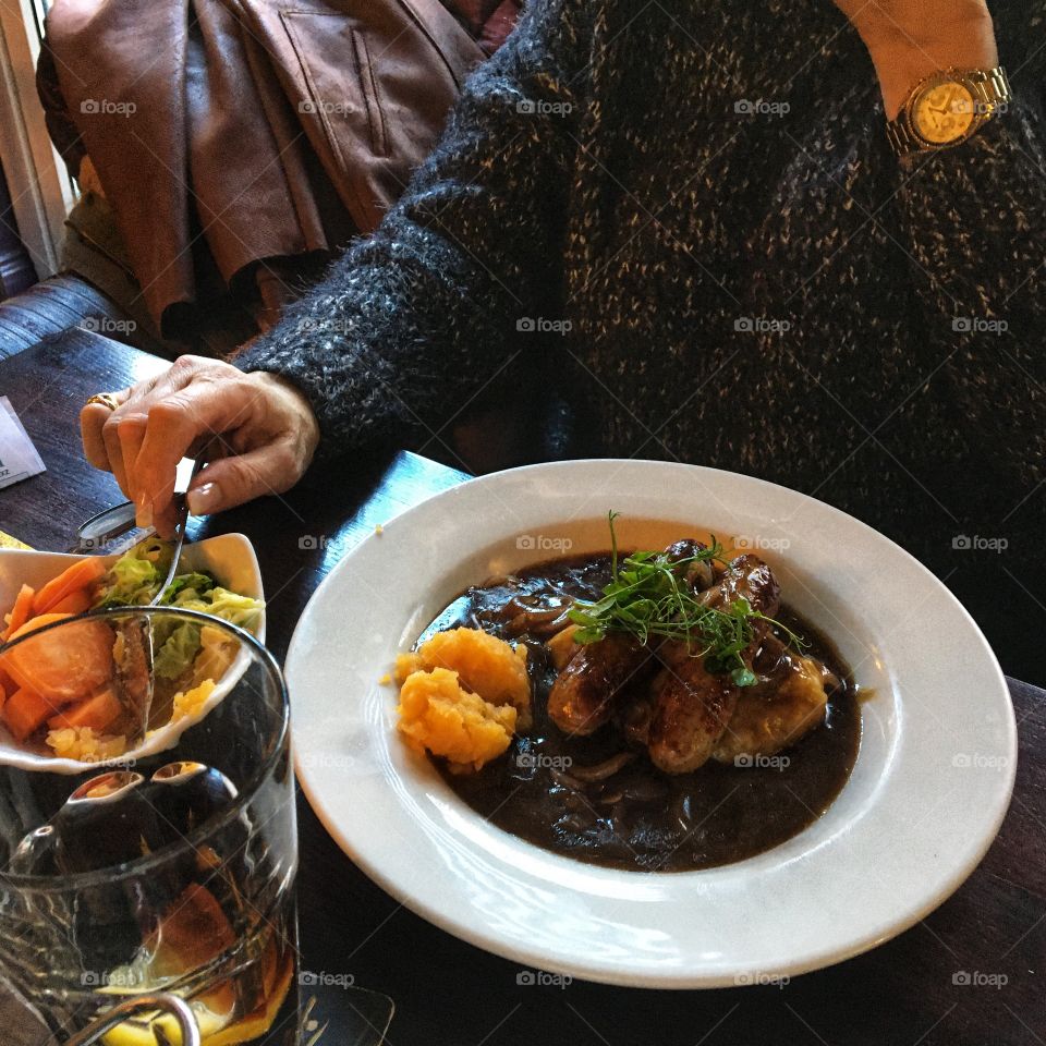 Sausage and mash served with rich onion gravy and mixed vegetables 