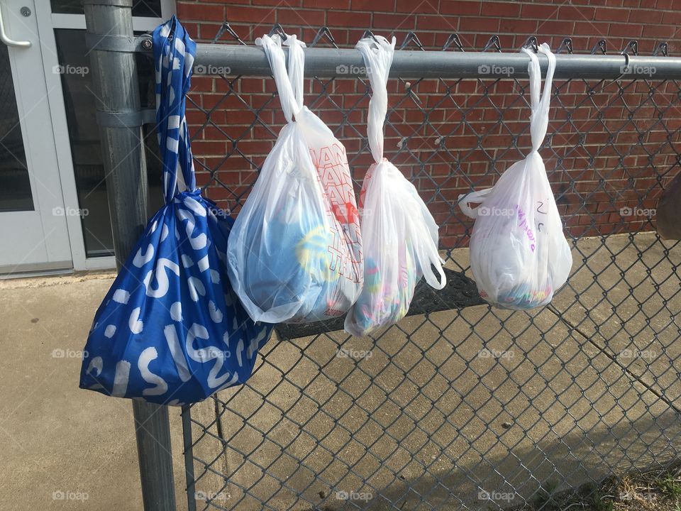 Eco-friendly reusable bag versus wasteful plastic bags.