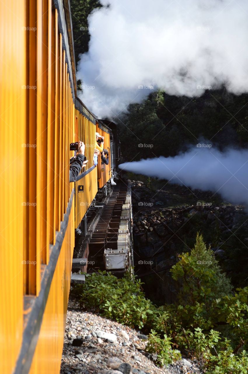 This is the beginning of the long ascent from Durango to Silverton on the historic Narrow Gauge Railroad. This railroad trestle spans the Animus River. The steam coming out the side gives extra momentum for the long uphill trek.