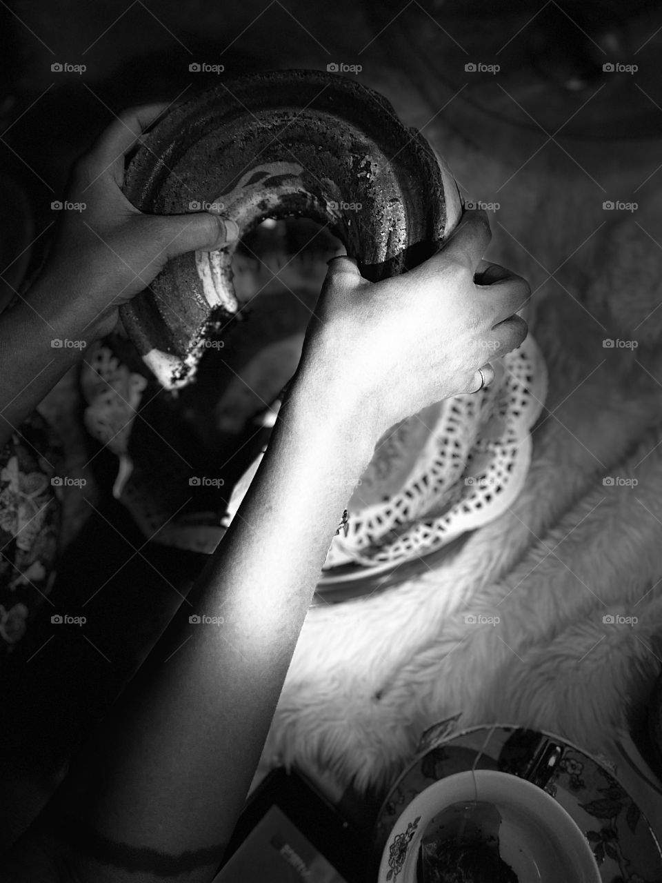 My sister holds the cake in her two hands and wants me to take a picture of it