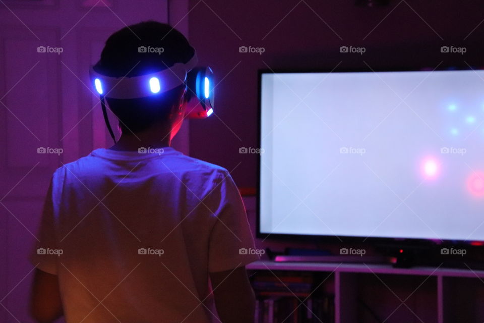 Boy playing virtual gaming system 