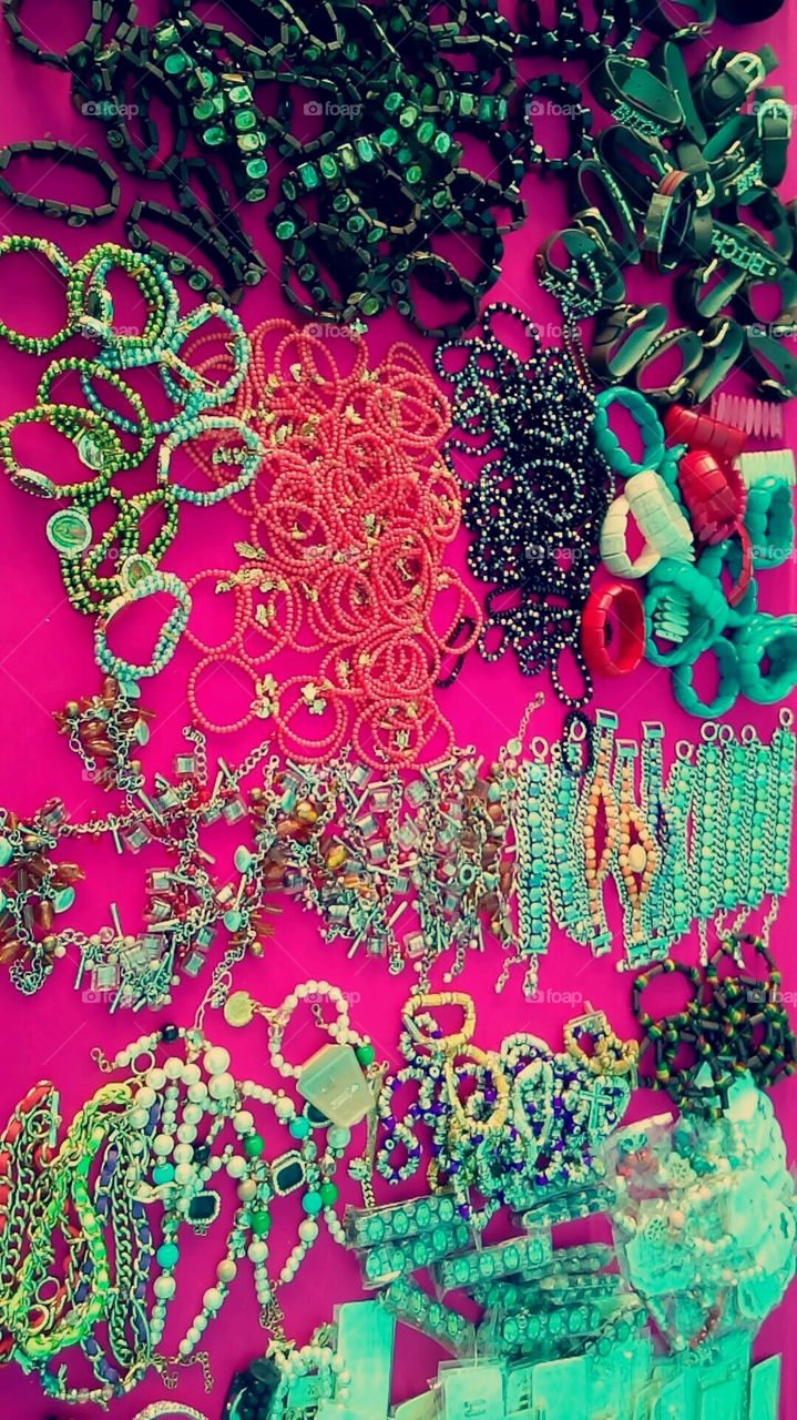 an assortment of Colorful  Bracelets laid out and ready to be bought at Galt Flea market in California.