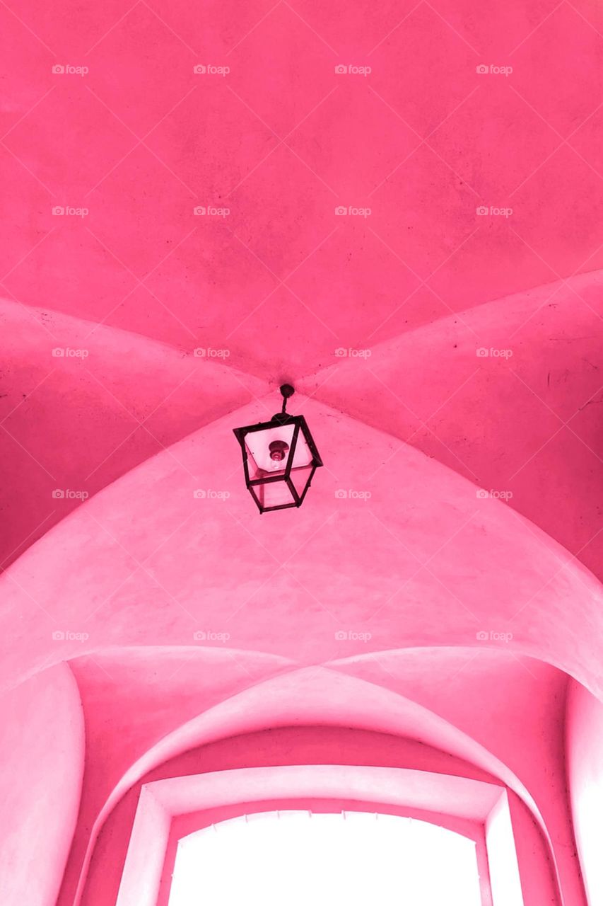 Vaulted ceiling with ceiling lamp in pink color