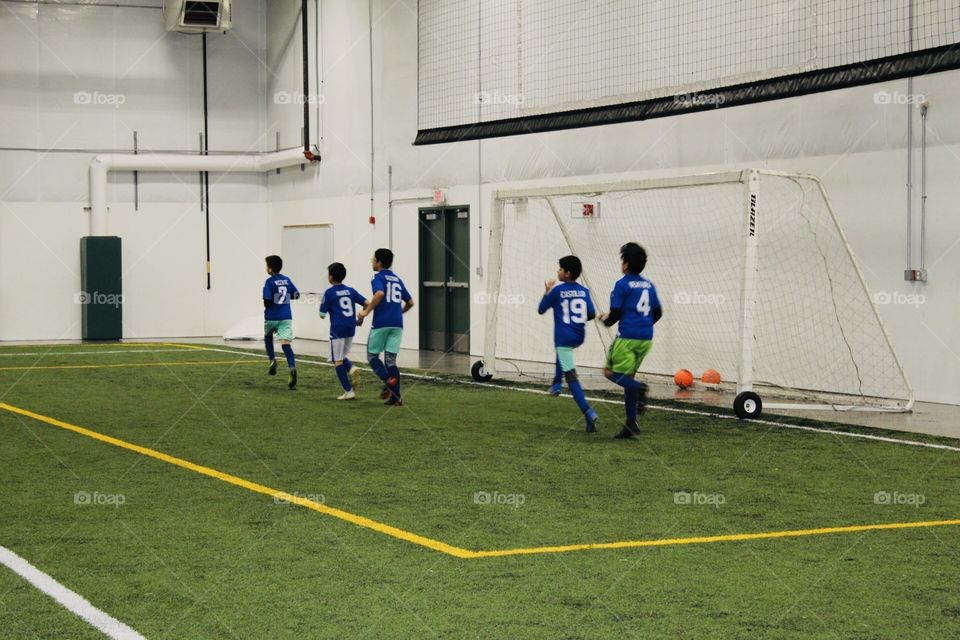 Boys playing indoor soccer 