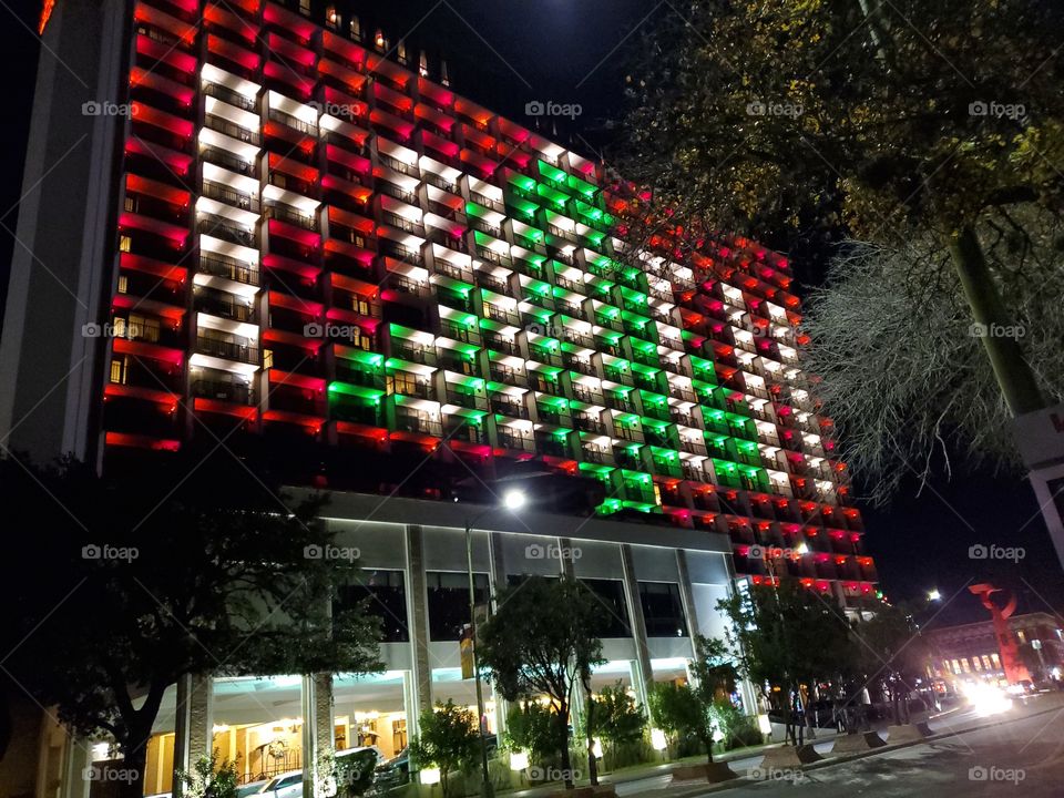 Hilton Palacio Del Rio Hotel balconies lighted for Christmas to create a Christmas tree and the word FAITH.