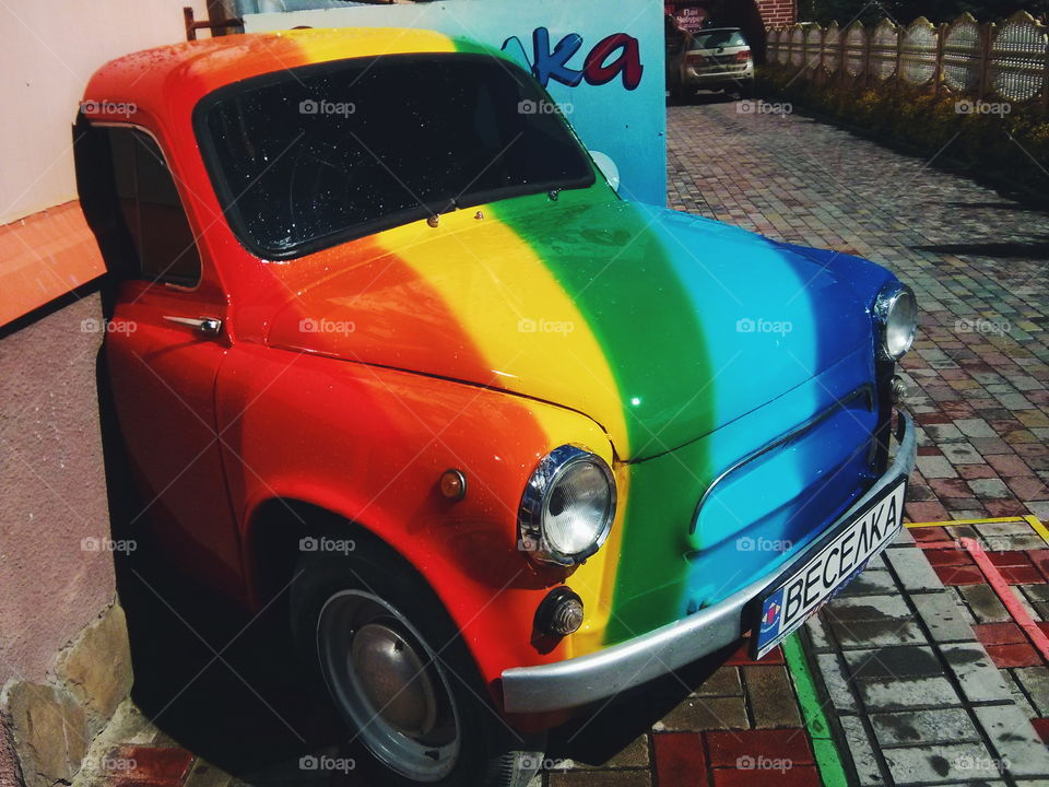 Retro car. Retro car stylized rainbow