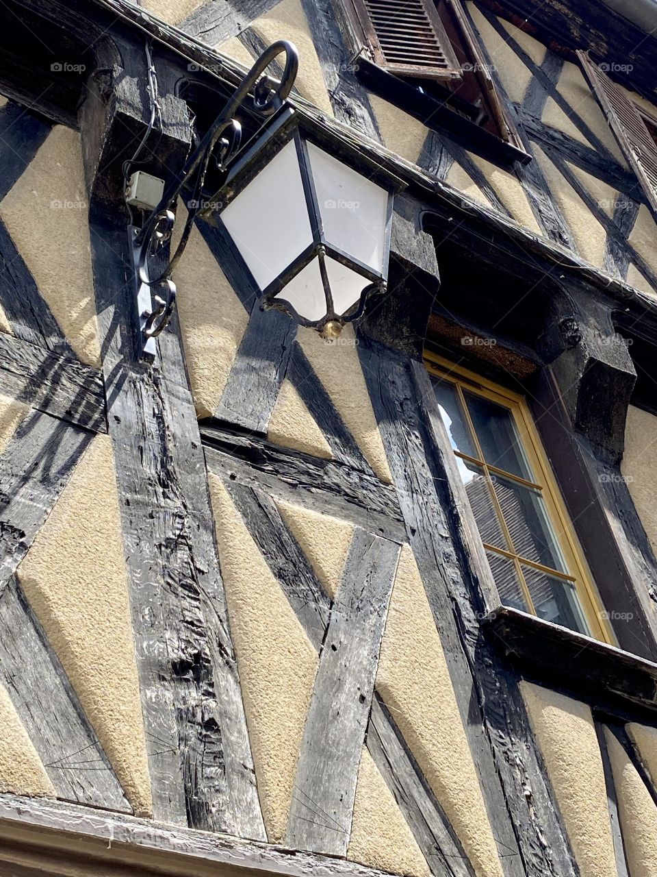 Lantern on the facade of an old house with exposed wooden beams