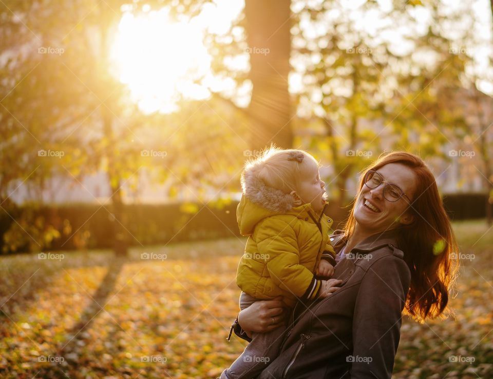 mother and doughter laughing in the park