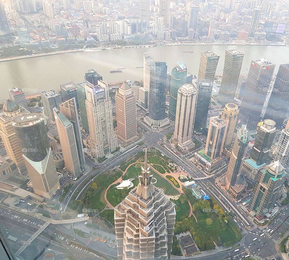 Looking down at Shanghai's Lujiazui finance district from the top of Shanghai Tower, currently the world's second tallest tower. The spire of Jin Mao Tower can be seen in the centre of this shot. Taken in May 2018.