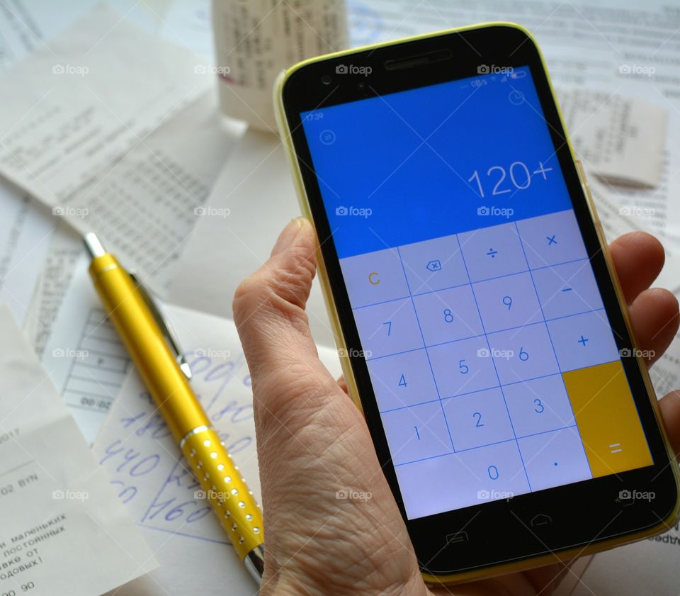 smartphone in the hand calculated debit and credit