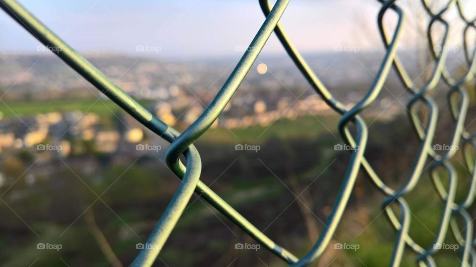 City viewed through a fence