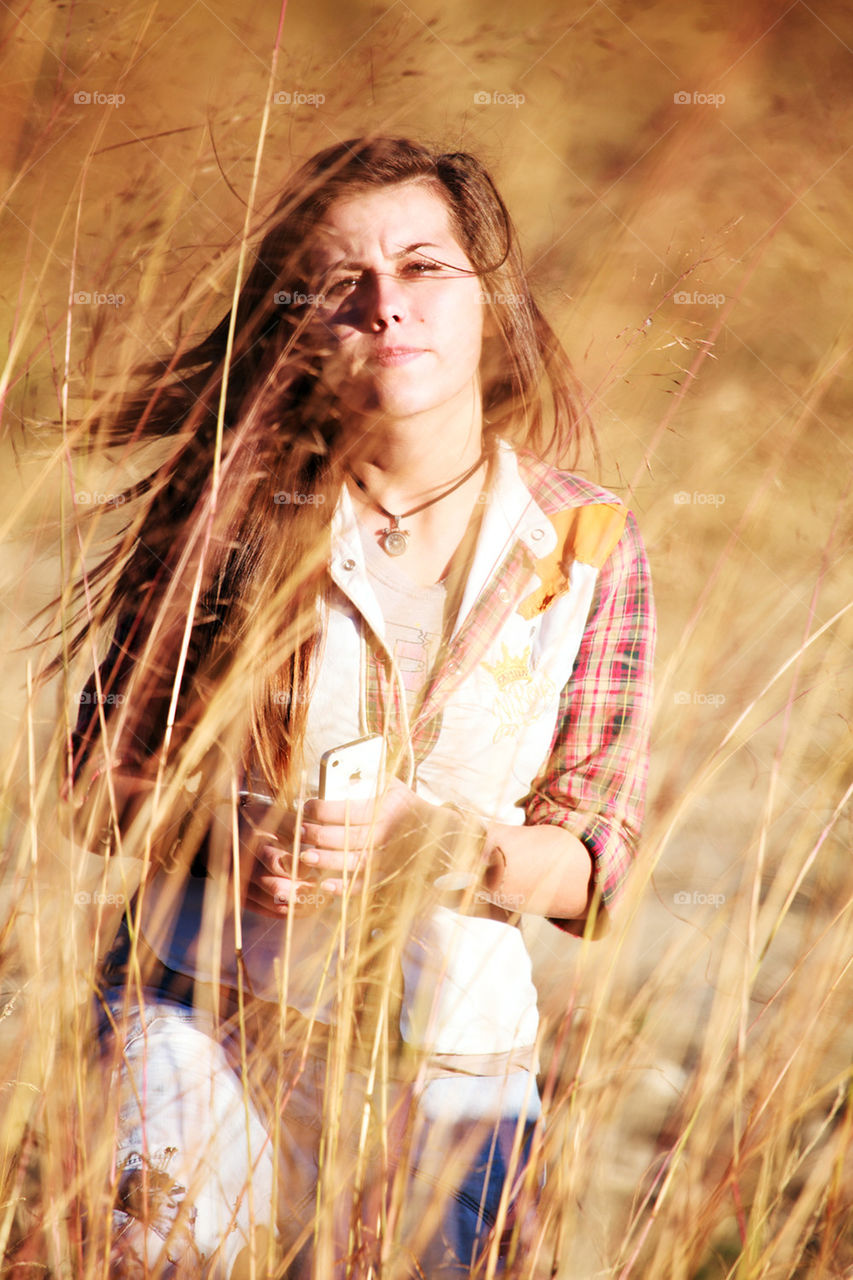 young cute girl in golden meadows