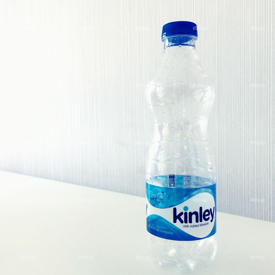 Kinley water bottle on a white table