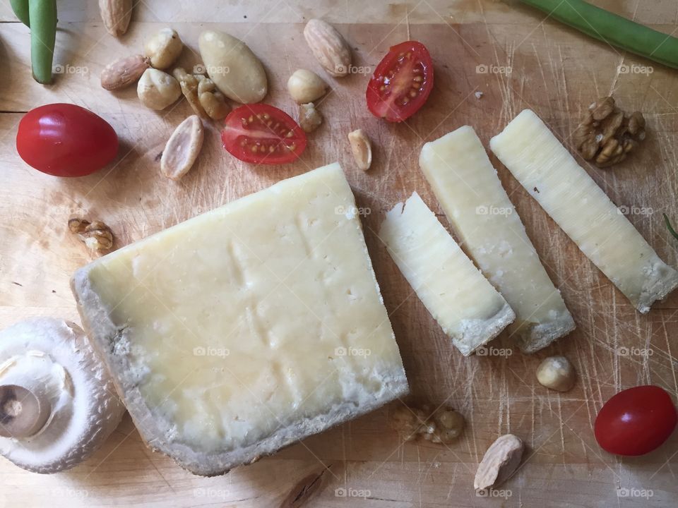 Cheese slices on the wooden board