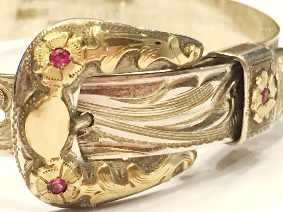 Hand engraved silver and gold jewelry with rubies. 

