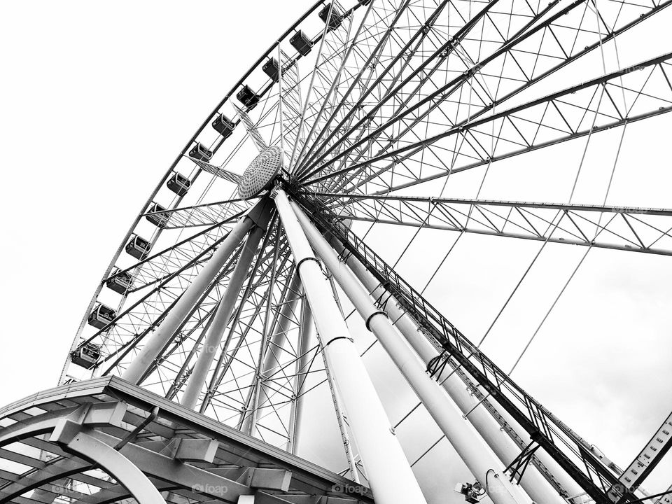 giant tall ferris wheel with lots of metal poles