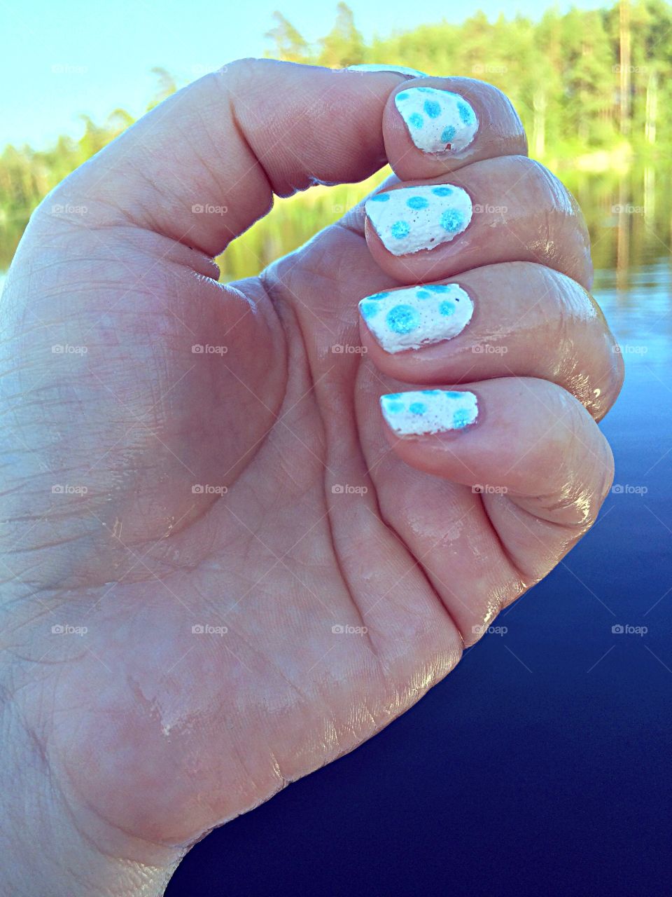 Cooling off. Wet hand after cooling it off in the lake