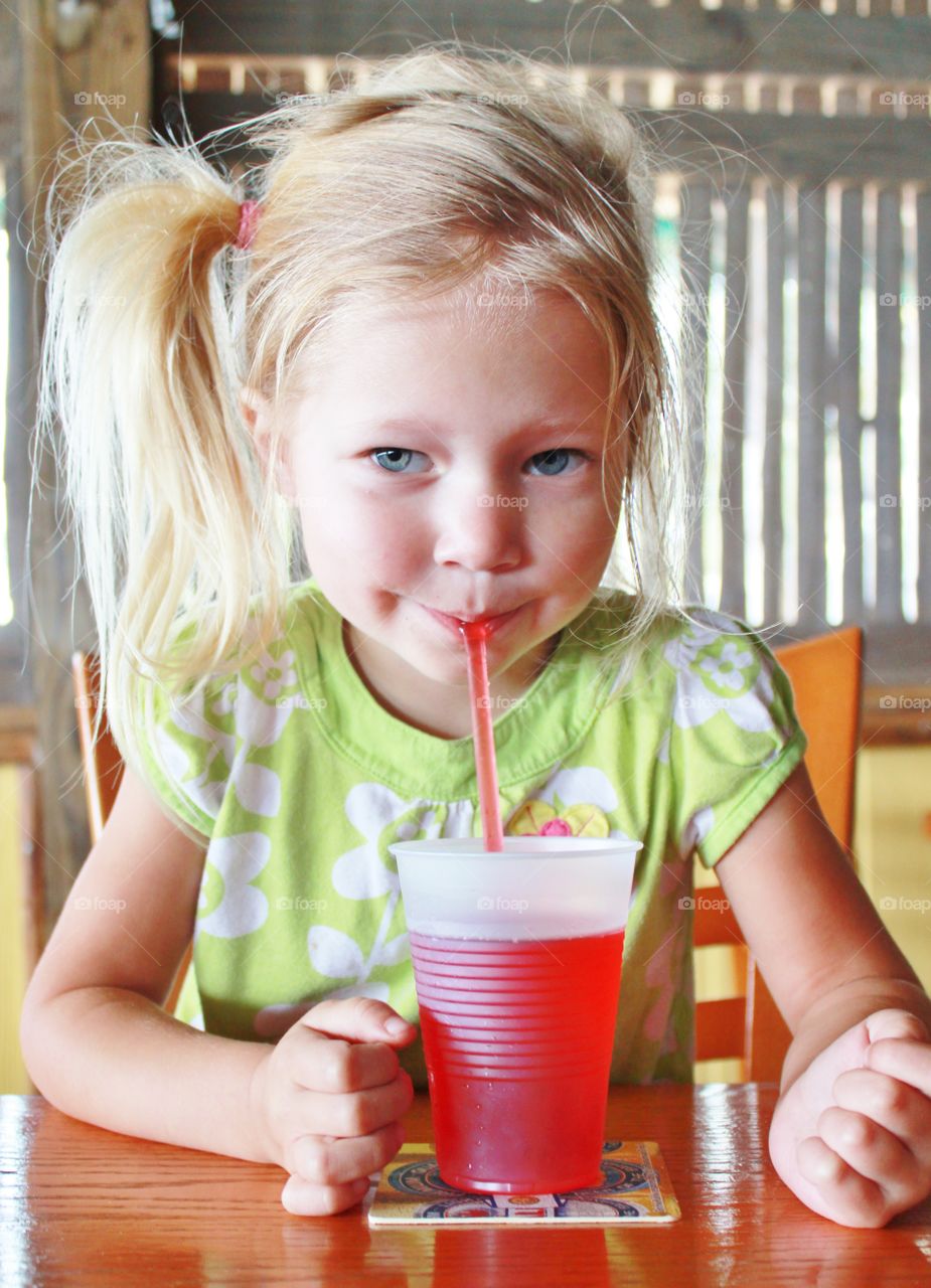 Young girl  drinking juice 