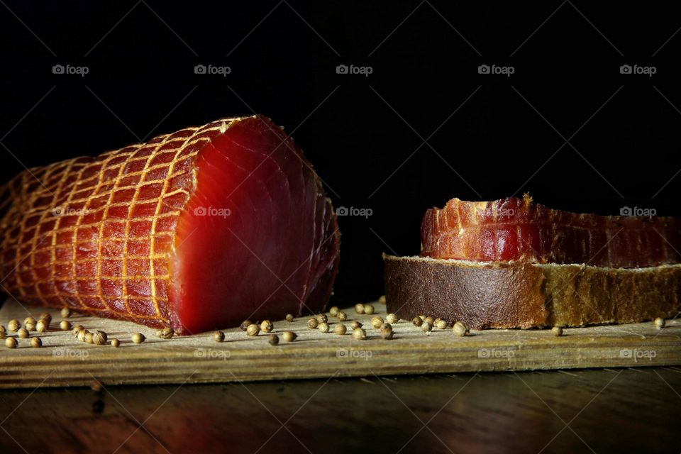 sea ​​cow fish fillet on a dark background on a kitchen board with bread