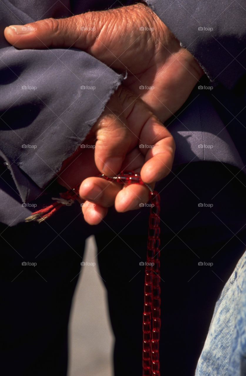 Armenian Prayer Beads. An old man in prayerful contemplation at Etchmiadzin Cathedral, in Armenia. Although not seen in this image, Armenian beads have a 'Khatchkar' Cross.