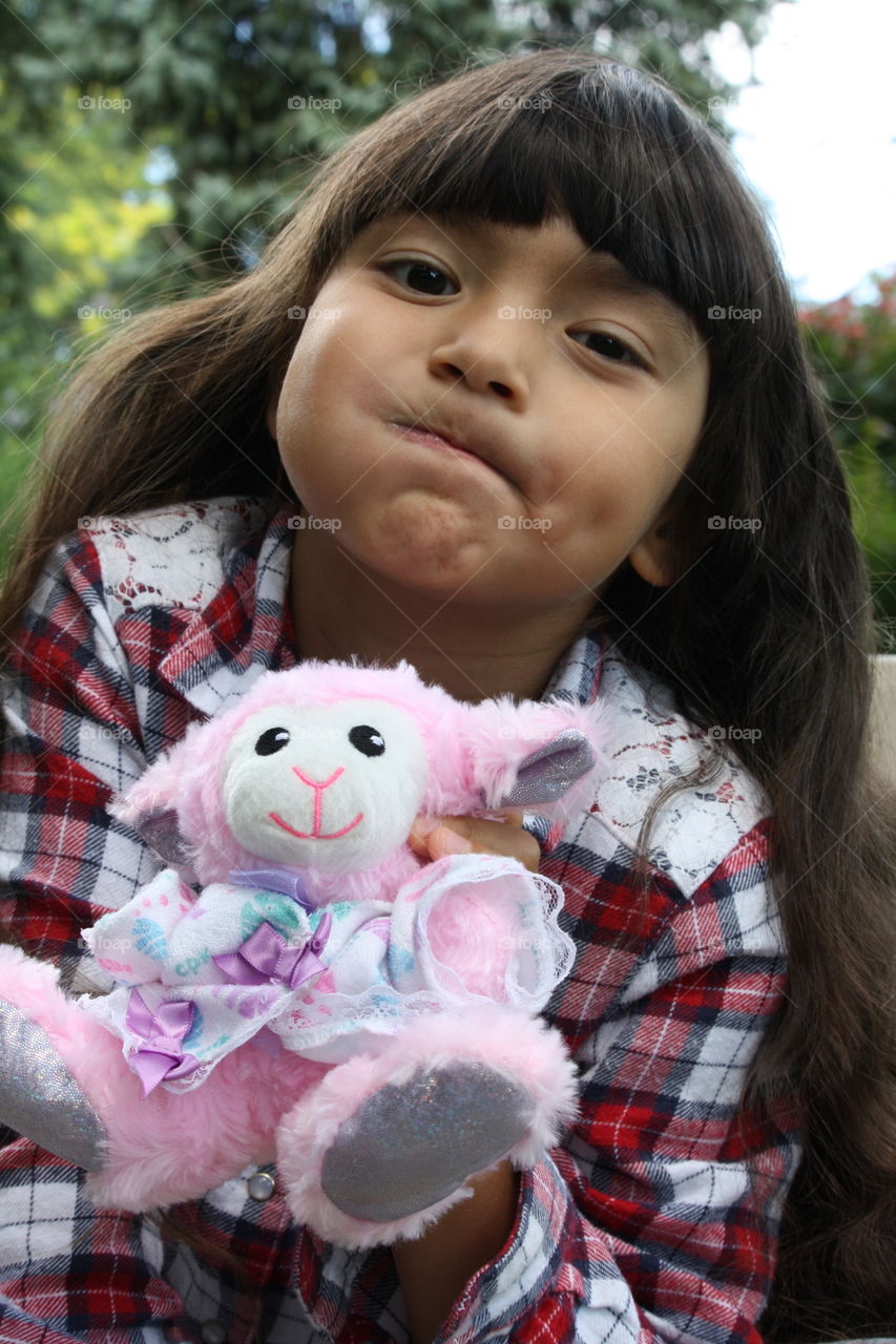 Cute little girl and her favorite plush toy