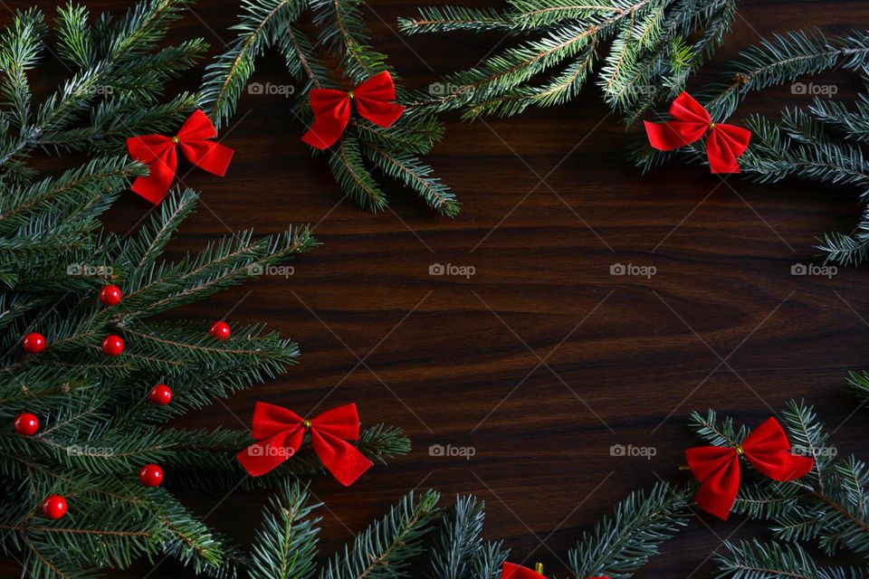 winter holiday background red ribbons and green fir branch top view