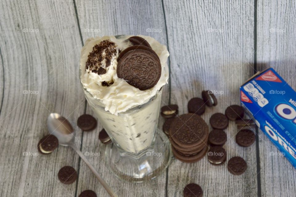 Oreo cookie milkshake with a wooden rustic white background
